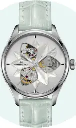  ??  ?? Architectu­ral design elements and mechanical mastery meet in the Jazzmaster Open Heart Lady by Hamilton ($1,145). True to its name, this timepiece offers intriguing glimpses of the watch’s inner movement, the new H-10 decorated caliber. Rendered in...