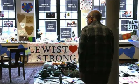  ?? Charles Krupa/Associated Press ?? Volunteer Rich Beard looks over archived items, many of which were left at memorials outside shooting sites, at the Maine Museum of Innovation, Learning and Labor, last month in Lewiston, Maine.