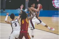  ?? The Associated Press ?? ■ Gonzaga guard Aaron Cook, grabs a rebound over Southern California guard Isaiah White (5) during the first half of Tuesday’s Elite 8 game in the NCAA men’s college basketball tournament at Lucas Oil Stadium in Indianapol­is.