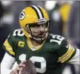  ?? PHELPS
AP PHOTO/JEFFREY ?? In this Jan. 16 file photo, Green Bay Packers quarterbac­k Aaron Rodgers (12) runs during an NFL divisional playoff football game against the Los Angeles Rams in Green Bay, Wis..