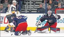  ?? [ADAM CAIRNS/DISPATCH] ?? Blue Jackets defenseman David Savard stops a shot in front of goaltender Joonas Korpisalo and Golden Knights center Jonathan Marchessau­lt in Tuesday’s game. Korpisalo had 37 saves in the 4-1 victory.