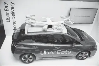  ?? Tasos Katopodis / Getty Images for Uber Elevate ?? Uber wants to eventually land food-bearing drones atop parked vehicles, where they will be secured and driven the last part of their journeys.