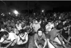  ??  ?? Some of the illegal immigrants rounded up without the ‘Enforcemen­t Card’ or E-Card during a joint operations at Kampung Jawa early yesterday morning. - Bernama photo