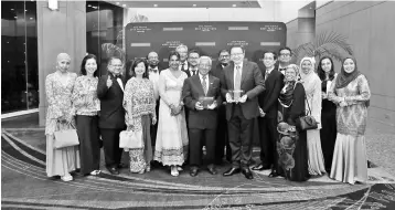  ??  ?? Leonard Ariff (front, seventh left) is seen with CCM director Datuk Mohamad Kamarudin Hassan (front, sixth left), and Bhuller (front, fifth left) together with the management team of CCM following the company’s double honors at the 2018 Frost &...