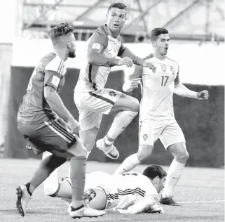  ?? AFP PHOTO ?? Portugal’s forward Cristano Ronaldo ( center) scores a goal during the FIFA World Cup 2018 football qualifier between Andorra and Portugal at the Municipal Stadium in Andorra la Vella.