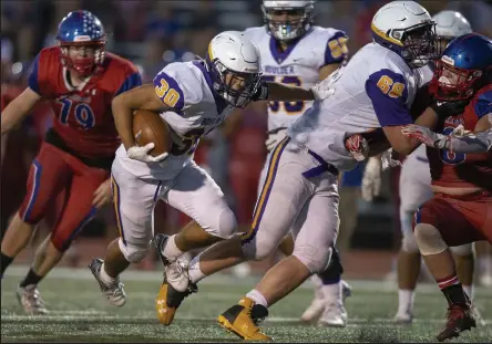  ?? Timothy Hurst / Staff Photograph­er ?? Boulder’s Declan Culberson, center, runs behind his blockers against Centaurus on Thursday night at Spangenber­g Field in Lafayette.