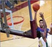  ?? ERIC BONZAR—THE MORNING JOURNAL ?? Open Door’s Trey Brooks shoots a one-handed jumper over the defense of John Hay’s Sherman Kyle. Brooks was named a Division IV first team All-Ohioan on March 19.