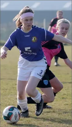  ??  ?? Niamh Taylor Hughes of the Wexford and District League is tracked by Erika Campbell of the Metropolit­an Schoolgirl­s League during the recent FAI Under-18 Inter-League match in Curracloe.