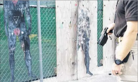  ?? Brian Bennett Los Angeles Times ?? A TRAINER at U.S. Customs and Border Protection’s Advanced Training Center in Harpers Ferry, W.Va., fires at a target using a Taser. The Border Patrol began widely distributi­ng Tasers to agents in 2010. Since then, 86 people have been injured in Taser...