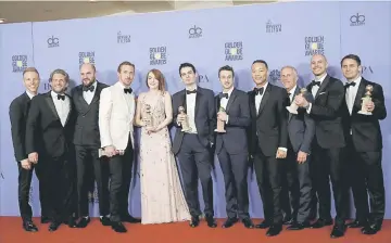  ??  ?? The cast and crew of ‘La La Land’ pose after winning the award for Best Motion Picture - Musical or Comedy among other awards backstage during the 74th Annual Golden Globe Awards.