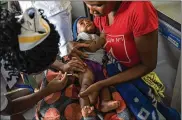  ?? JEROME DELAY / AP ?? Malawi residents have their children become test subjects for the world’s first vaccine against malaria in three African nations. World health officials want to see how well the vaccine works before wider use.