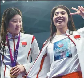  ?? XINHUA AND WEI XIAOHAO / CHINA DAILY ?? Chinese Olympic champion Zhang Yufei (right) won the women’s 200m butterfly title at the 19th Asian Games in Hangzhou, posting a new Games record in the process.