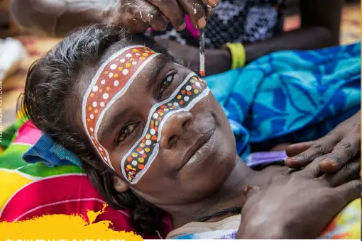  ??  ?? ABOVE TO RIGHT: Preparing for the afternoon bunggul (traditiona­l dance); ' Yothu Yindi' - ' mother/child relationsh­ip' has a special place in the Yolngu world. One that signifies harmony and balance.