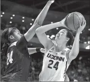  ?? AP/JESSICA HILL ?? Ruthy Hebard (left) tries to block a shot by Connecticu­t forward Napheesa Collier during the Bridgeport Regional final of the NCAA Women’s Basketball Tournament on Monday. Collier had 28 points, 12 rebounds and 4 blocks as the Huskies whipped the Ducks...