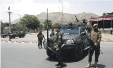  ?? Reuters ?? Afghan security forces keep watch at the site of a suicide attack in Kabul. Eight people at a gathering of clerics were killed