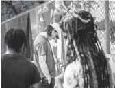  ?? BRANDON BELL/GETTY ?? Mourners pay their respects this week at a makeshift memorial outside NRG Park, site of the deadly Astroworld music festival, in Houston.