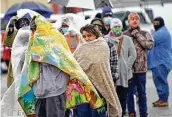  ?? David J. Phillip / Associated Press ?? Customers wait for over an hour in freezing rain Feb. 17 to fill their propane tanks in Houston. Millions in Texas had no power after the arctic blast.