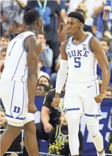  ?? JEFF BLAKE/USA TODAY SPORTS ?? Duke forwards RJ Barrett (5) and Zion Williamson (1) survived a second-round scare against UCF.