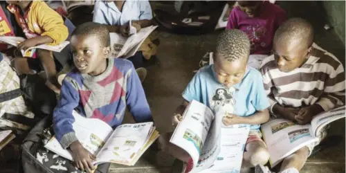  ??  ?? Wearing backpacks and surrounded by a pile of books, the children aged six and seven are gripped by the teacher's every word -- a concentrat­ion level almost impossible to achieve in Portuguese.