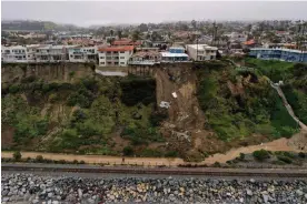  ?? AFP/Getty Images ?? A swimming pool sits on the edge of a landslide below an apartment building following heavy rains from a winter storm in San Clemente, California. Photograph: Patrick T Fallon/