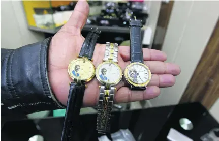  ?? Sabah Arar / AFP ?? Watches bearing portraits of late Iraqi president Saddam Hussein are some of the collector’s items sold in Baghdad.