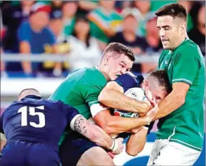  ?? BEHROUZ MEHRI/AFP ?? Ireland fly-half Jonathan Sexton (second left) fights for the ball during the Japan 2019 Rugby World Cup Pool A match against Scotland at the Internatio­nal Stadium Yokohama in Yokohama on September 22.