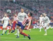  ?? GETTY IMAGES ?? ■ Jose Gimenez of Atletico Madrid battles for the ball with Raphael Varane of Real Madrid in Madrid.