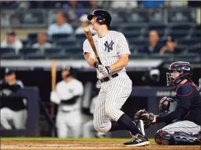  ?? John Minchillo / Associated Press ?? The New York Yankees’ DJ LeMahieu hits a single off Cleveland Indians starting pitcher Zach Plesac in the first inning on Friday.