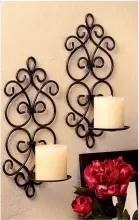  ??  ?? Dazzling duo! Just add pillar candles to these classic iron sconces to fill any room with elegance and ambiance! $24.95 for 2, Home ’n Gifts (Amazon.com, style #B00M3D3DMY).