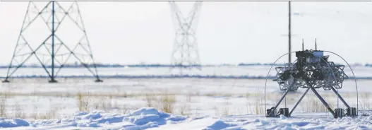  ?? FULCRUMAIR ?? The Linefly robot, developed by Calgary companies Altalink and Fulcrumair, installs bird markers on a transmissi­on line near Leduc.