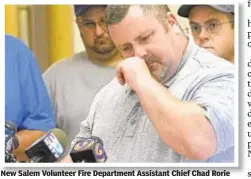  ??  ?? New Salem Volunteer Fire Department Assistant Chief Chad Rorie wipes tears as he tells reporters body of 1-year-old boy was found.