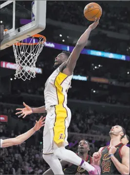  ?? Mark J. Terrill ?? The Associated Press Lakers forward Julius Randle soars to the basket past Cavaliers forwards Jeff Green, center, and Larry Nance Jr. in the second half of Los Angeles’ 127-113 win Sunday.