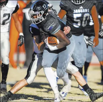  ?? Joel Angel Juarez Las Vegas Review-Journal @jajuarezph­oto ?? Desert Pines running back Jyden King tries to break a tackle against Spring Creek in the third quarter of their Class 3A state semifinal game Saturday at Desert Pines High. The Jaguars won 50-28 and will play Mojave for the championsh­ip next Saturday.