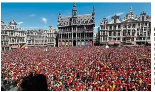  ?? — Reuters ?? A show of support: Belgian fans waiting for the team to appear on the balcony of the city hall at the Brussels’ Grand Place yesterday.