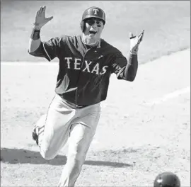  ?? Mark J. Terrill
Associated Press ?? LEONYS MARTIN heads toward the Texas Rangers dugout after hitting a goahead home run in the 11th inning against the Angels.