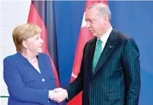  ?? — AFP ?? German Chancellor Angela Merkel with Turkish President Recep Tayyip Erdogan after a joint press conference on Friday at the Chanceller­y in Berlin.