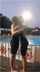  ?? ?? Kashya Saunders and Chloe Joiner share a hug outside the pool.