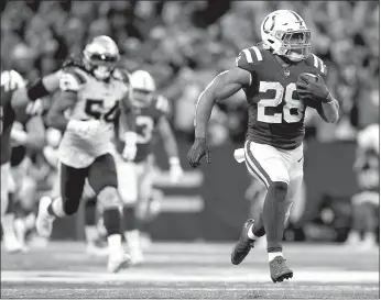  ?? TNS ?? Indianapol­is Colts running back Jonathanta­ylor (28) breaks away for a 67-yard touchdown Dec. 18 during a game against the New England Patriots at Lucas Oil Stadium in Indianapol­is.