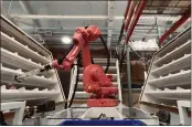  ?? BALAZS GARDI — THE NEW YORK TIMES ?? Covariant's AI-powered Robotic Putwall system autonomous­ly sorts items at the company's headquarte­rs.