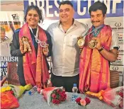  ?? — DC ?? Olympic medallist and coach Gagan Narang (center) poses with his wards Dhanush Srikanth (right) and Surabhi Rapole after felicitati­ng them at the Gun For Glory Academy in Hyderabad on Saturday.