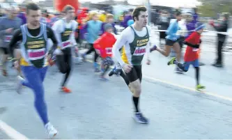  ?? CLIFFORD SKARSTEDT/EXAMINER FILE PHOTO ?? Andy Hein of Fleming College (155) leads a pack of runners at the start of last year's YMCA Half Marathon, Half-a-Half, 5K Walk/Run and Kids 1K Fun Run in support of the YMCA Strong Kids Campaign on Feb. 26, 2017 in Peterborou­gh, Ont.