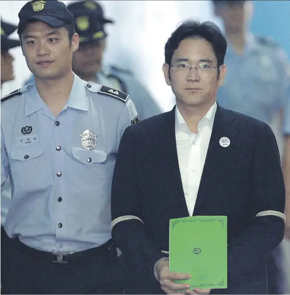  ?? AHN YOUNG-JOON/AFP/GETTY IMAGES ?? Lee Jae-yong, centre, vice-chairman of Samsung Electronic­s and heir to the business empire, arrives for his trial in Seoul on Monday. Lee, who has denied all bribery-related charges, may be the first in his family to serve a prison term if convicted.