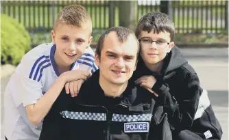  ??  ?? PC Peter Baker and his sons Adam and Luke who have written a song for COPS (Care of Police Survivors).