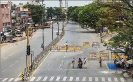  ??  ?? Traffic police personnel block a road during an intensifie­d lockdown as a preventive measure against the spread of Coronaviru­s disease, in Chennai, on Sunday