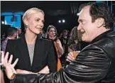  ?? DIMITRIOS KAMBOURIS/GETTY ?? Quentin Tarantino fan-crushes on Charlize Theron.