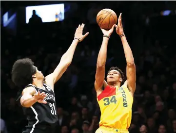  ?? — USA TODAY Sports photo ?? Milwaukee Bucks forward Giannis Antetokoun­mpo shoots the ball over Brooklyn Nets center Jarrett Allen during the second half at Barclays Center.