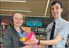  ?? ?? Donna Saxby, Inveraray Co-op staff member, receives a bunch of flowers from Jack Coggins.