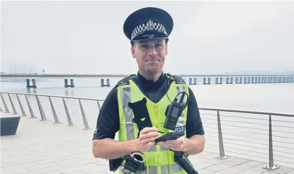  ??  ?? PC Garrie Watson, of Tayside Division, using one of the new mobile devices.