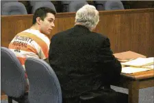  ?? JEFF GUERINI / STAFF ?? Ely Serna and his attorney, Dennis Lieberman, talk before a hearing in Champaign County Common Pleas Court.