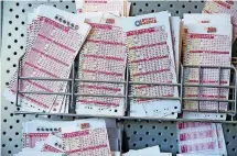  ??  ?? Lottery tickets sit in a display to be sold at a QuikTrip in Tulsa on Thursday.